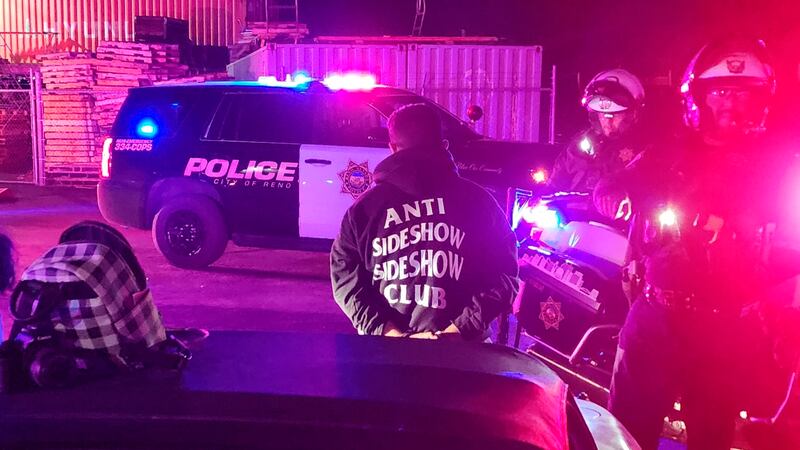 Police detain drives in Reno, Nev., early Saturday, Oct. 1, 2022. Hundreds of cars took over...