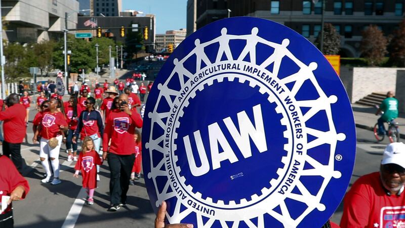 FILE - United Auto Workers members walk in the Labor Day parade in Detroit, Sept. 2, 2019. The...