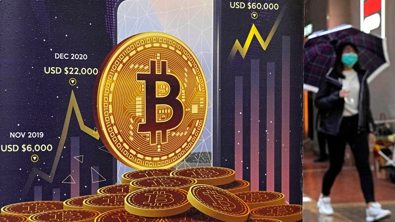 FILE - An advertisement for Bitcoin cryptocurrency is displayed on a street in Hong Kong, on...