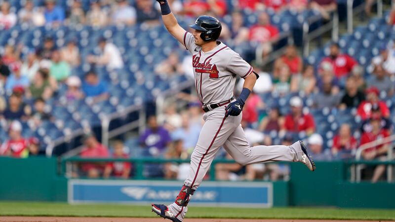 Atlanta Braves' Austin Riley gestures as he rounds the bases after hitting a two-run home run...