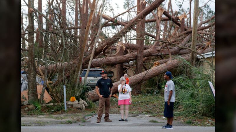 FILE PHOTO: Joyce Fox, center stands in front of her heavily damaged home in the aftermath of...