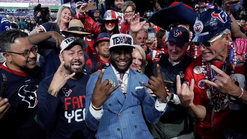 Alabama linebacker Will Anderson Jr. celebrates with fans after being chosen by the Houston...